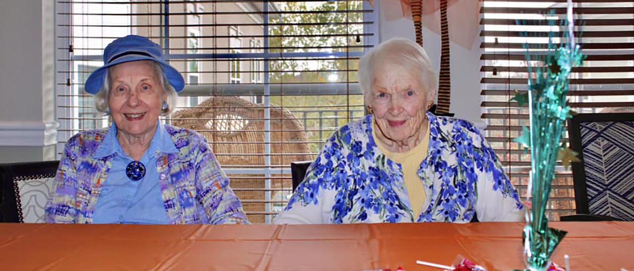 two classy senior women smiling for the camera